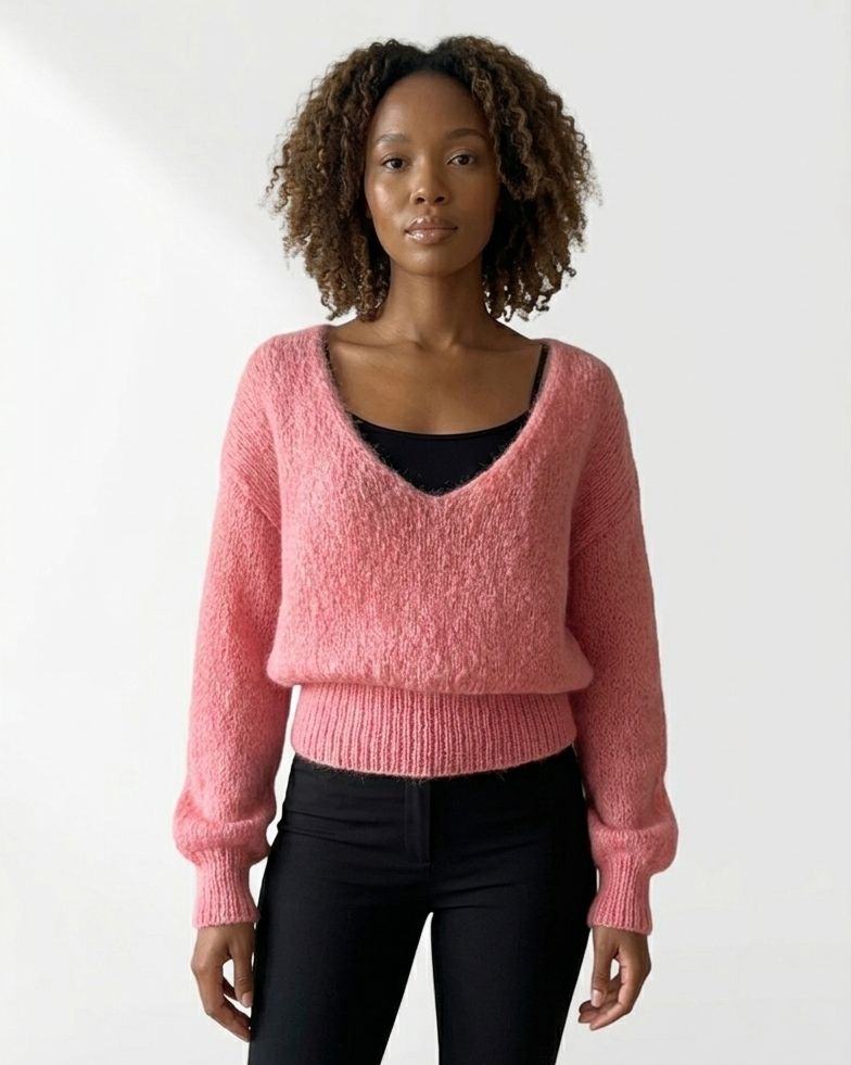 South African model wearing pink mohair-blend sweater with fluffy knit texture, deep scoop neckline, oversized sleeves. Full body studio shot highlighting South African craftsmanship, Studio Minimale